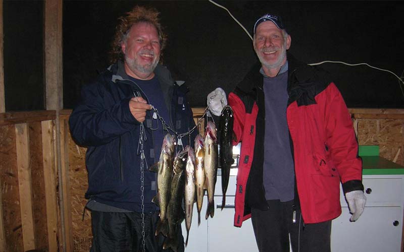 Deux heureux pêcheurs posant avec leur prises